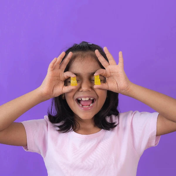 Child holding NutriBears gummies - Promoting Healthy Habits