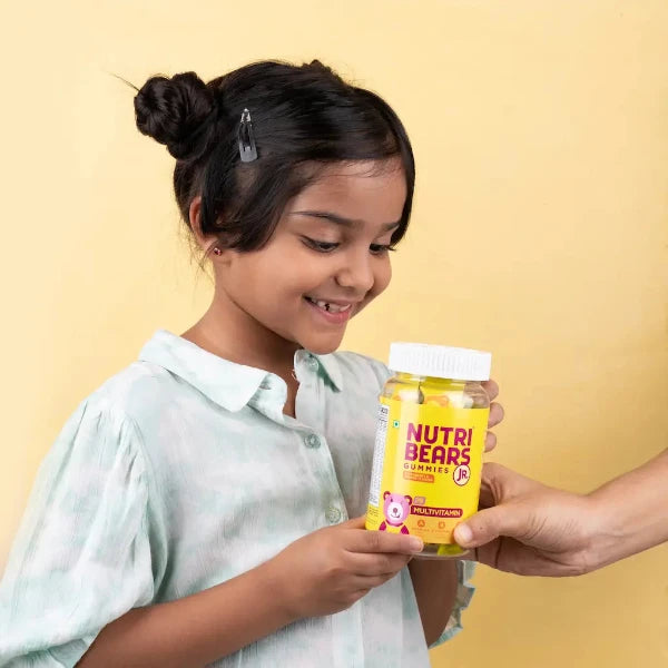 Child holding NutriBears gummies - Promoting Healthy Habits